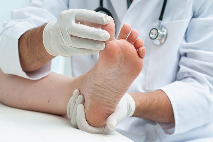 dermatologist examines patient's legs